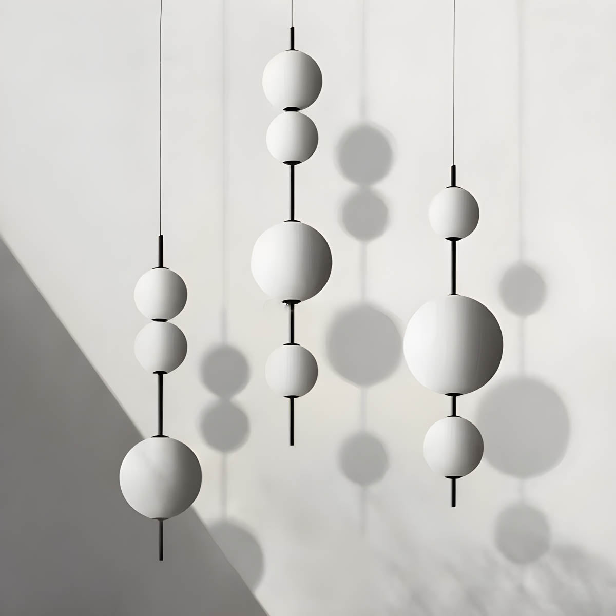 Triple glass globe pendant light, metal frame, 80-103 cm